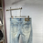 Light blue Versace jeans on hanger with front pockets and logo patch panel