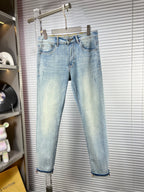 Light blue straight-leg jeans on hanger, cuffed hems and denim belt loops