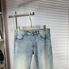 Light blue denim jeans with button fly, belt loops, and stitched front pockets