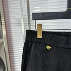 Versace dark jeans front with belt loops and small gold logo detail