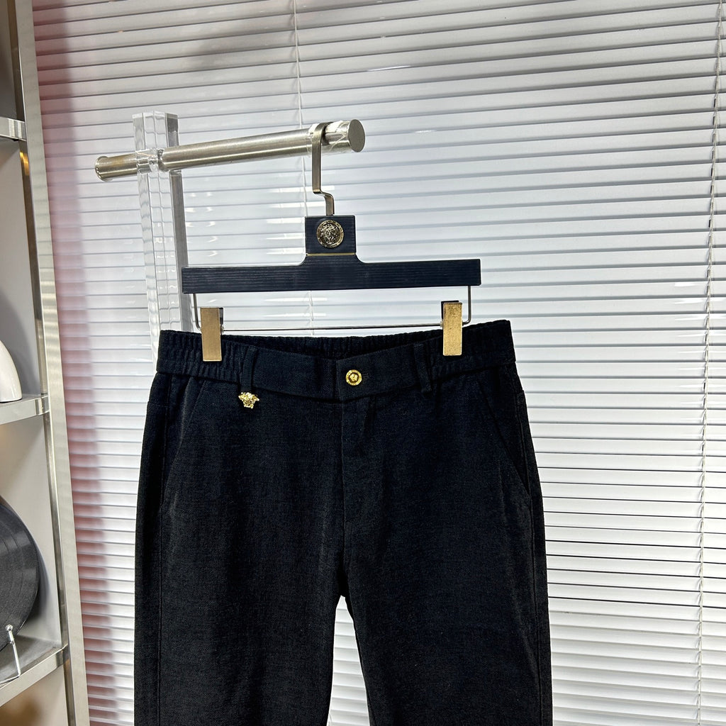 Versace dark jeans with elastic waistband and gold emblem button, front view