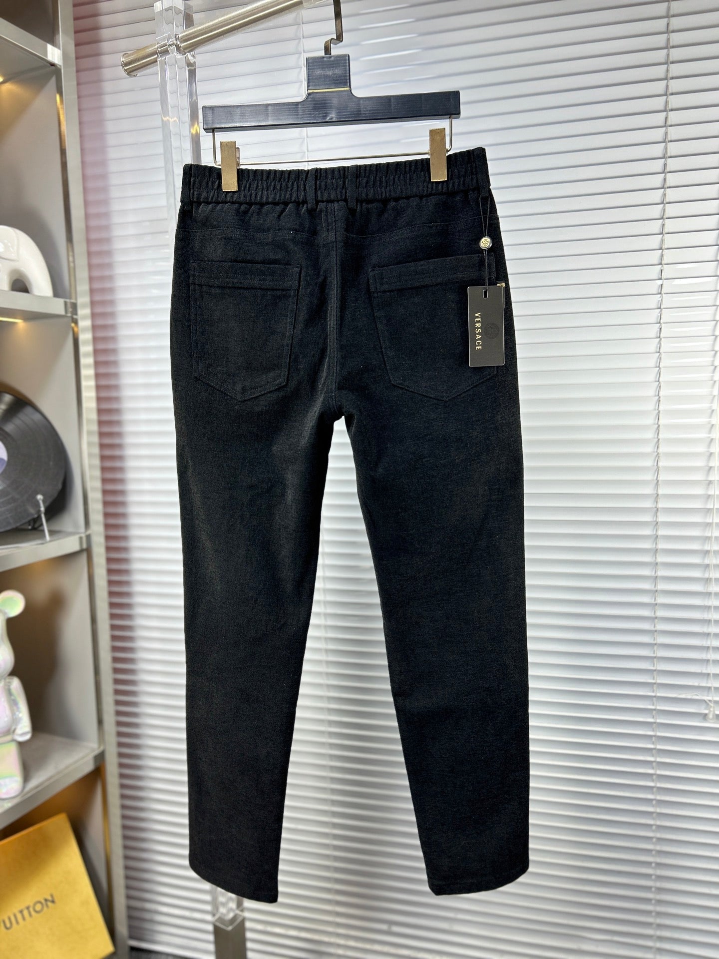 Versace dark jeans with front pockets, side label, and button waist
