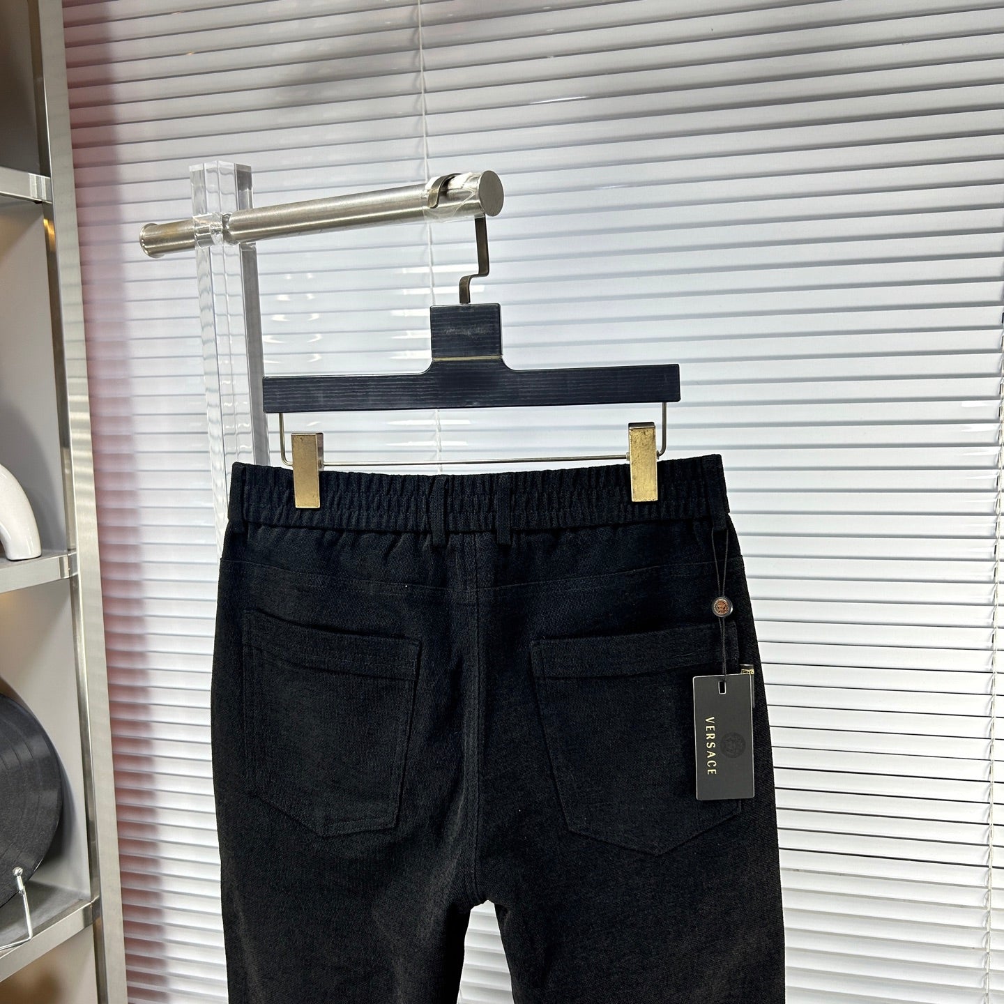 Versace dark jeans with front pockets, small side tag, and button waist