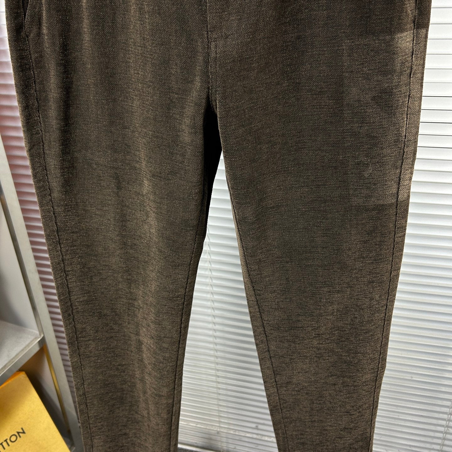 Versace trousers in dark brown textured fabric with tapered leg and no visible pockets