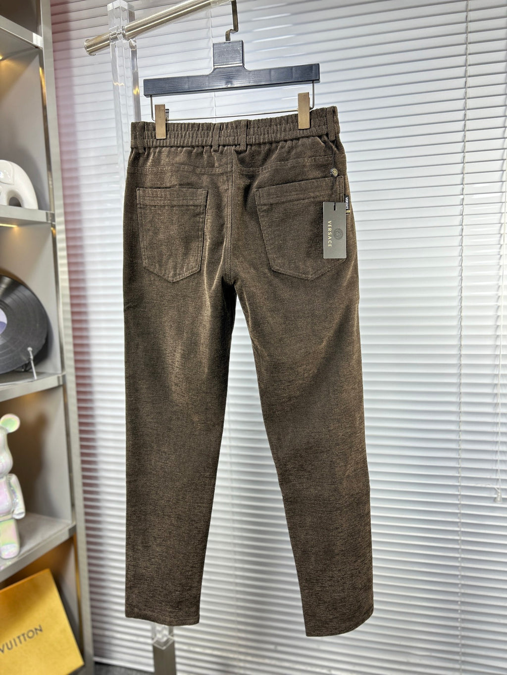 Versace trousers in dark brown textured weave, pleated front, side pockets, belt loops