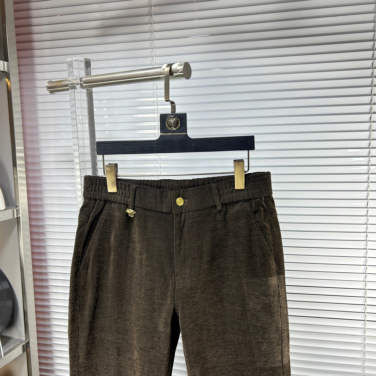 Versace trousers with dark brown waistband, gold button detail, belt loops, front pleats