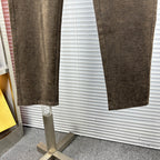 Versace trousers hem view showing tapered leg in dark brown textured fabric