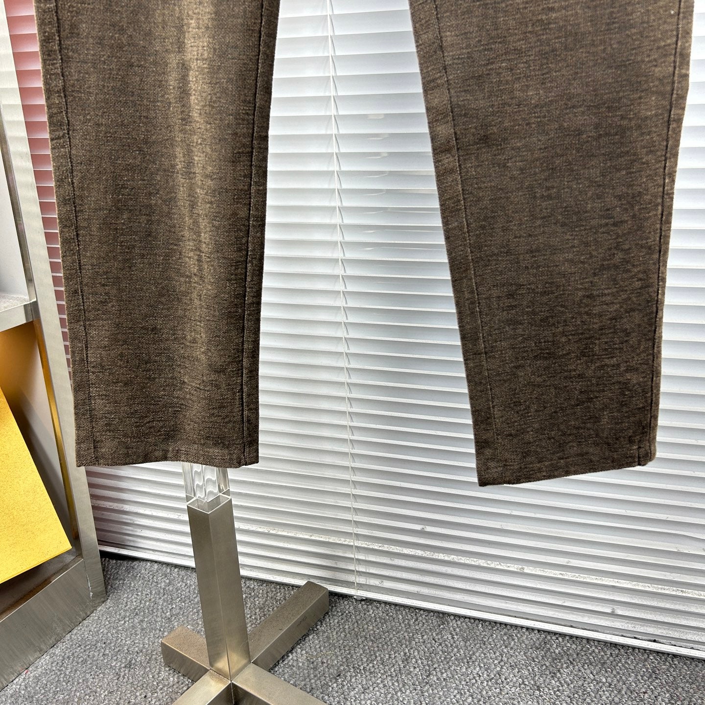 Versace trousers hem view showing tapered leg in dark brown textured fabric