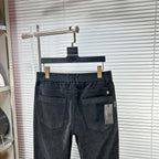 Dark denim trousers with two front pockets and buttoned fly