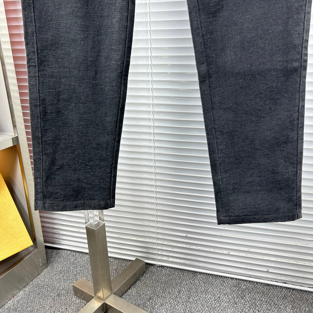 Dark trousers leg view with relaxed fit and tapered hem