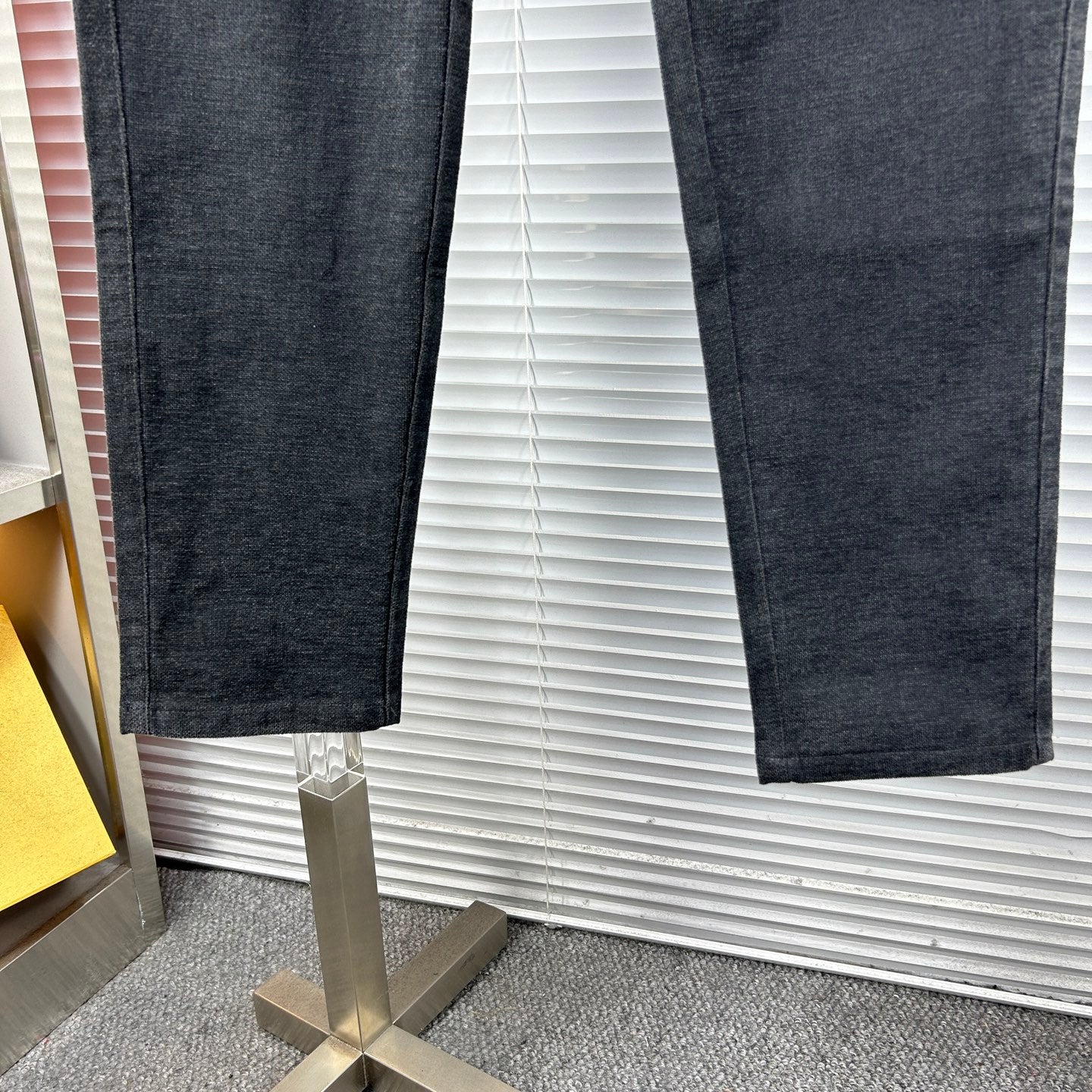 Dark trousers leg view with relaxed fit and tapered hem