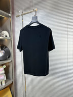 Black crew-neck T-shirt on hanger with short sleeves and subtle speckle detail