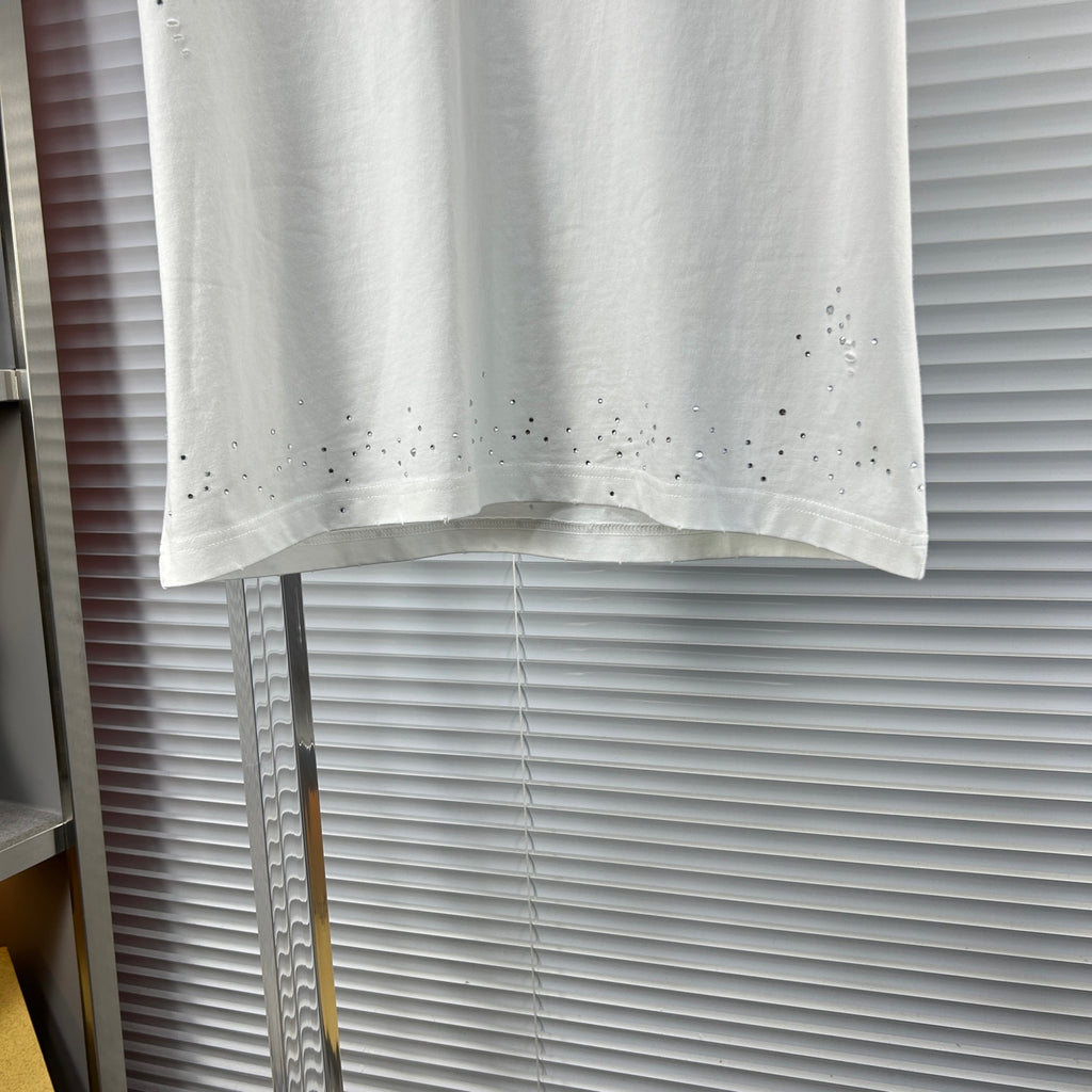 Versace white T-shirt hem with perforated stud detailing across the bottom