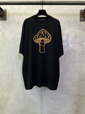 Black short-sleeve T-shirt with gold graphic of a mushroom emblem