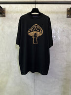 Black short-sleeve T-shirt with gold graphic of a mushroom emblem