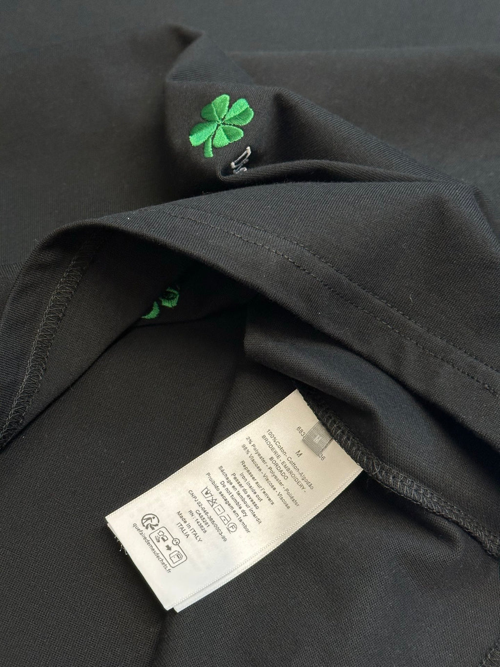 Black short-sleeve T-shirt with care label near hem and side seam