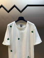 White crew-neck T-shirt with green clover embroidery and small Dior logo patch