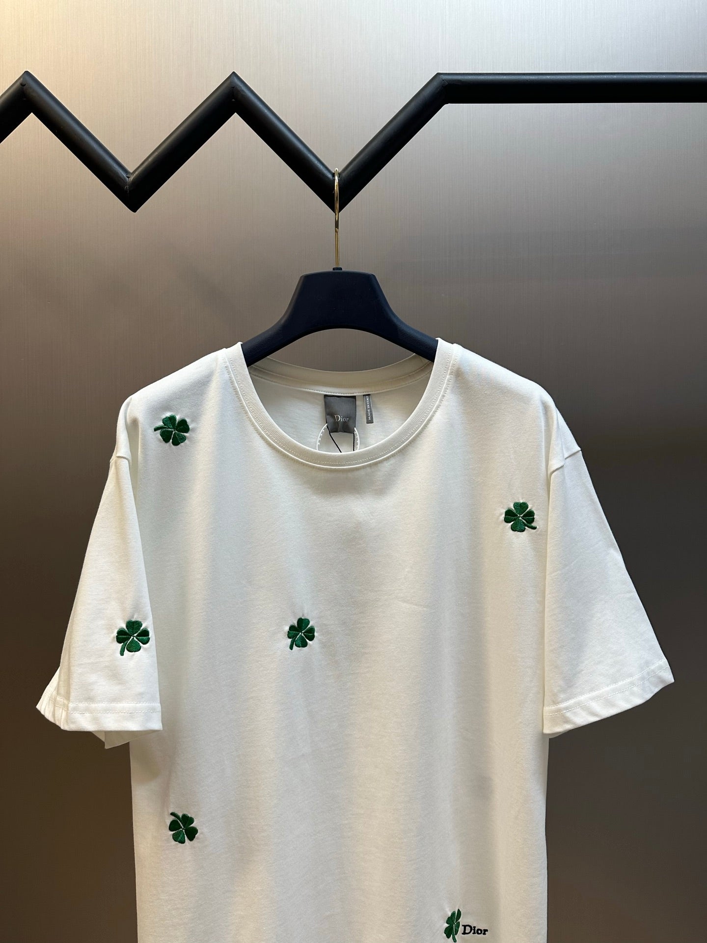 White crew-neck T-shirt with green clover embroidery and small Dior logo patch