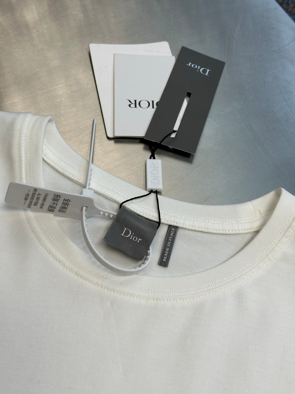 White crew-neck T-shirt with Dior logo and interior label tags