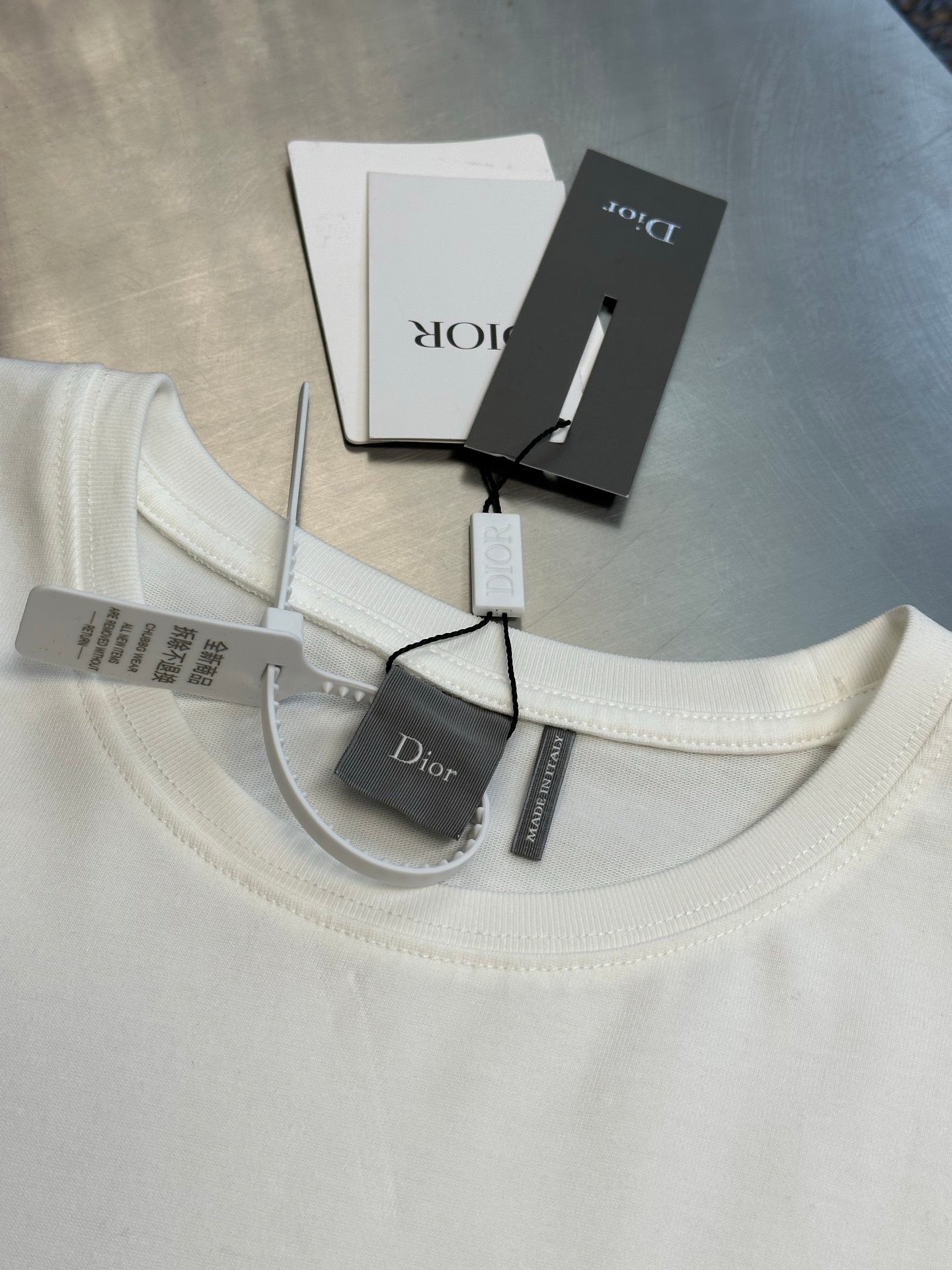 White crew-neck T-shirt with Dior logo and interior label tags