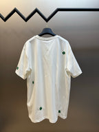 White crew-neck T-shirt with green clover embroidery on back