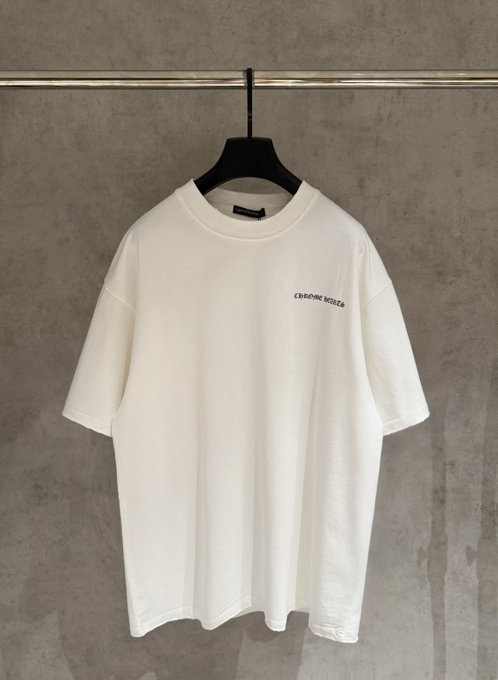 White short-sleeve T-shirt with small chest logo graphic