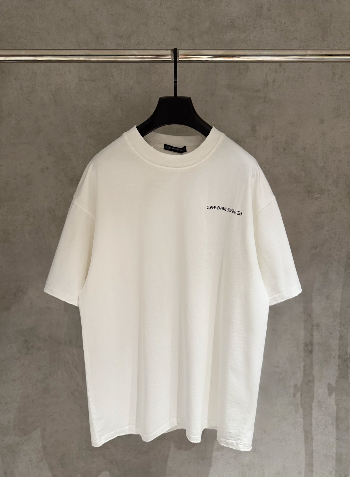 White short-sleeve T-shirt with small chest logo graphic