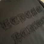 Black T-shirt with raised embossed wordmark text detail