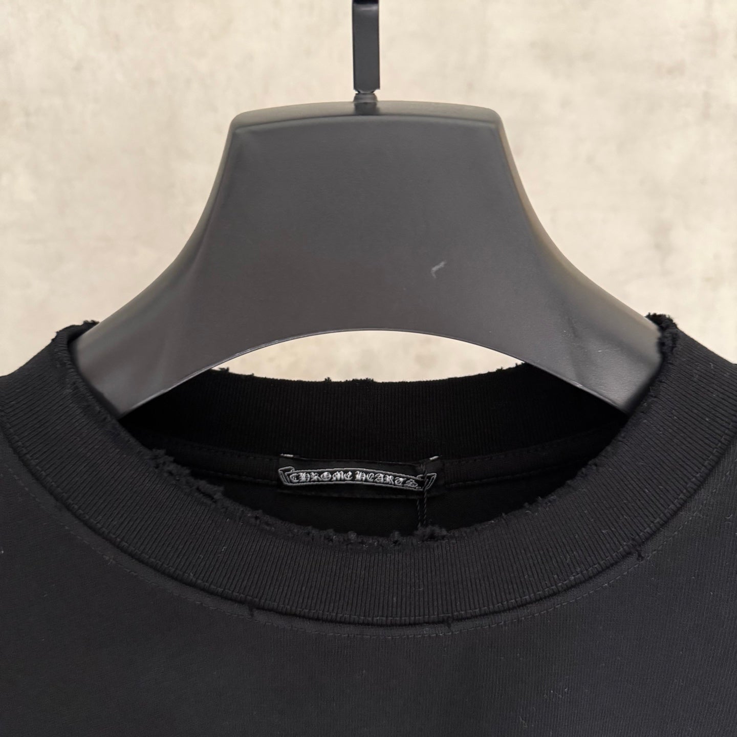 Black T-shirt neck label detail on inside collar