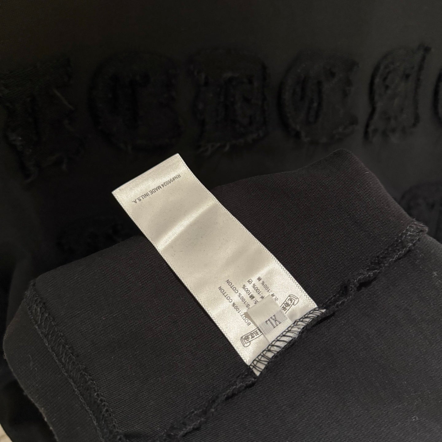 Black T-shirt care label on inside neck seam