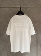 White crew-neck short-sleeve T-shirt with large raised embroidered logo on back.