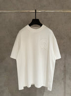 White crew-neck short-sleeve T-shirt with small raised embroidered logo on chest.