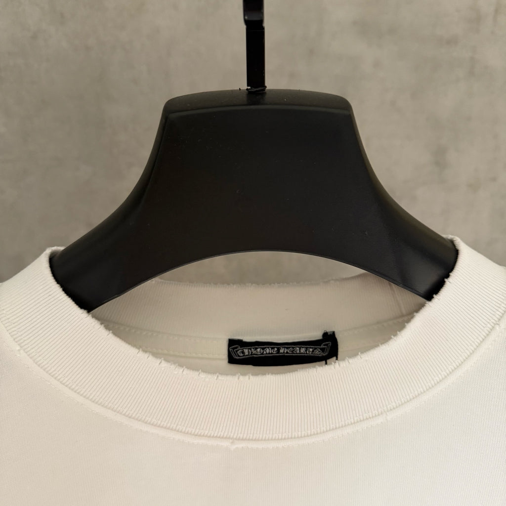 White crew-neck T-shirt collar with ribbed neckband and interior size label.