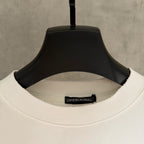 White crew-neck T-shirt collar with ribbed neckband and interior size label.
