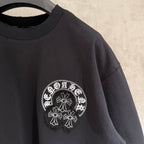 Black short-sleeve T-shirt with small white circular side chest graphic