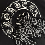 Close-up of white floral circular graphic on black short-sleeve T-shirt