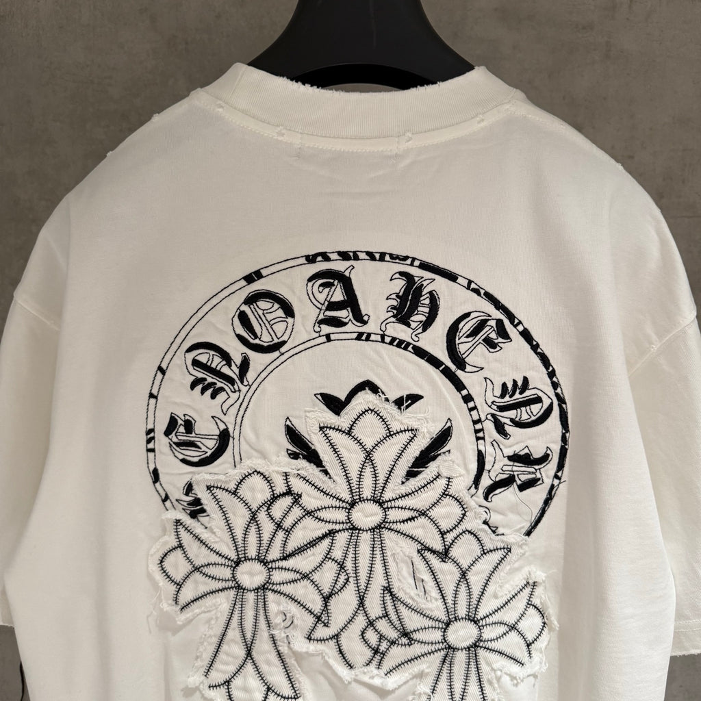 White T-shirt close-up of large back graphic wreath with floral appliques