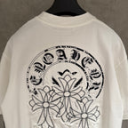 White T-shirt close-up of large back graphic wreath with floral appliques
