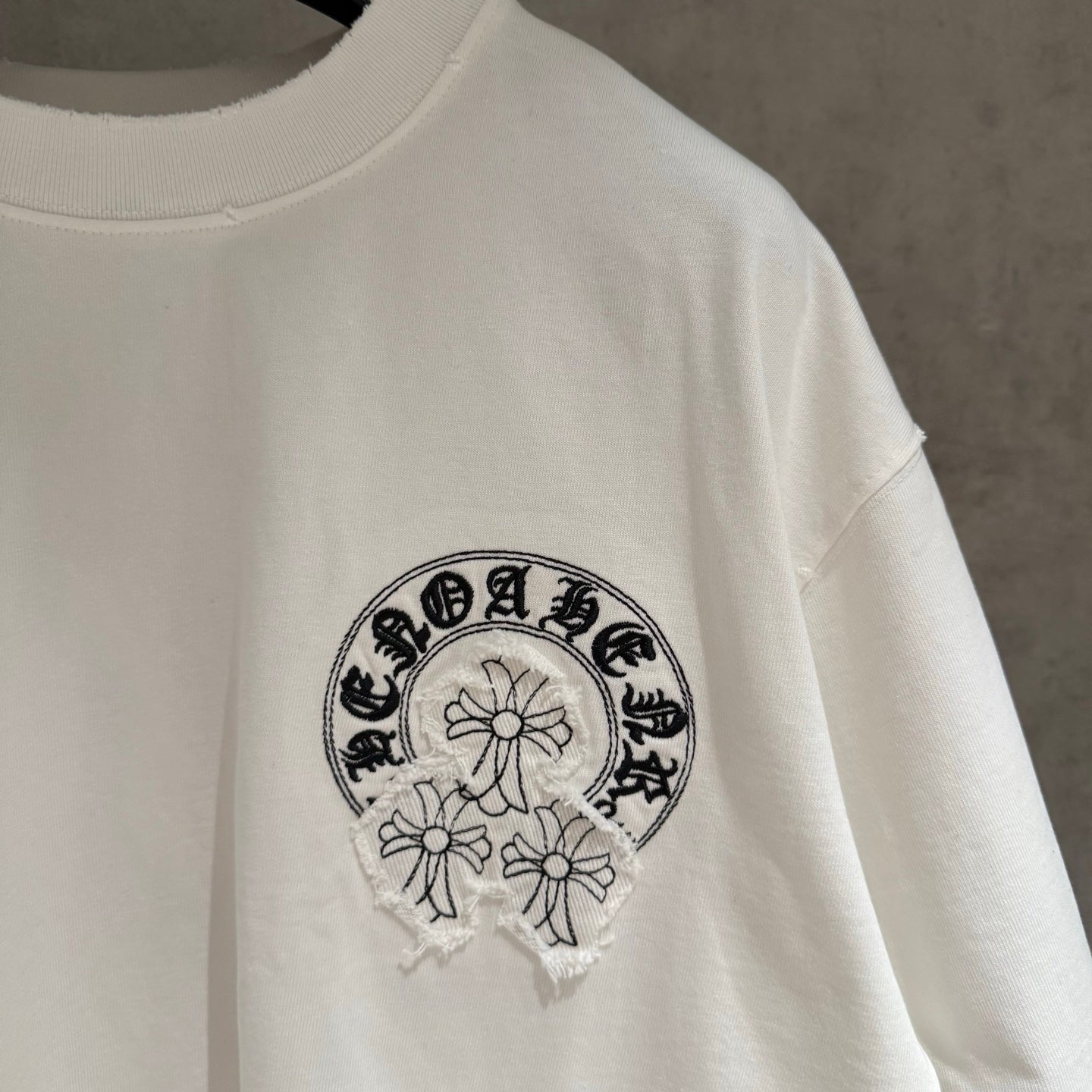 White T-shirt with embroidered chest logo graphic and crew neckline