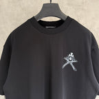 Black short-sleeve T-shirt neckline with small white cross emblem on the chest