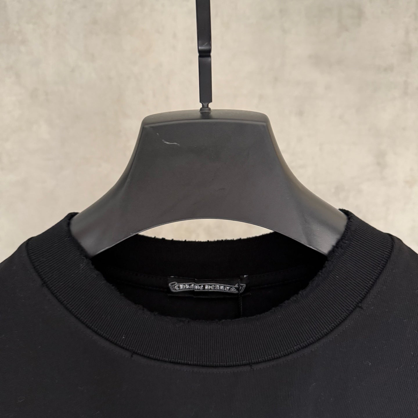 Black short-sleeve T-shirt with ribbed crew neck and inner neck label