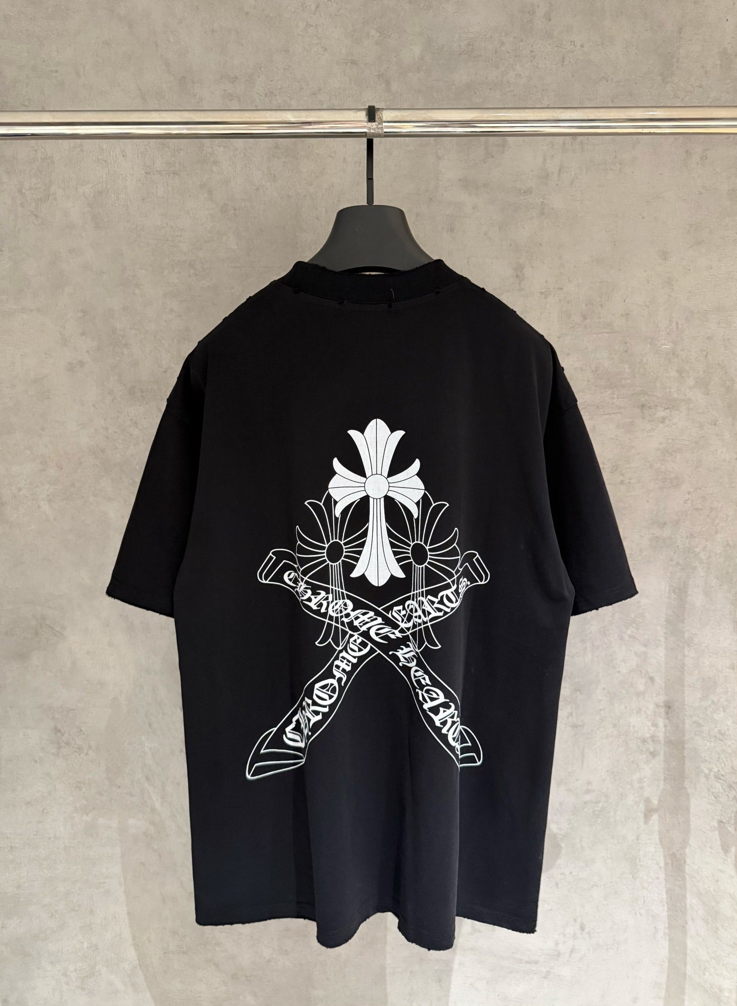 Black short-sleeve T-shirt with large white cross and flower graphic on the back