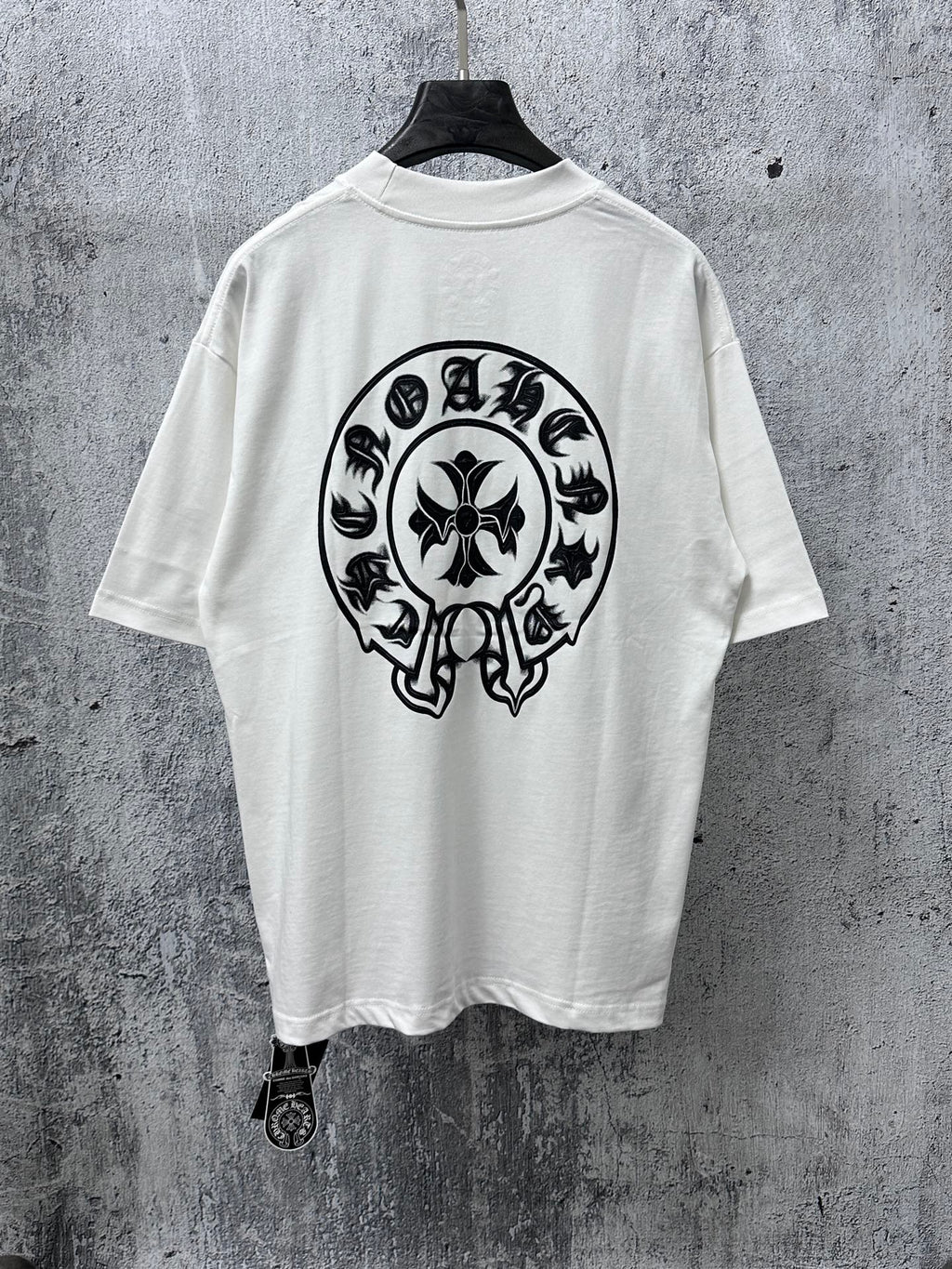 White short-sleeve T-shirt with large black circular skull graphic on the back