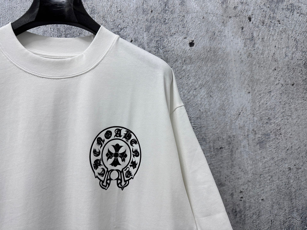 White short-sleeve T-shirt with small black circular skull graphic on the chest