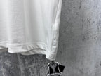White short-sleeve T-shirt hem with hanging brand tag