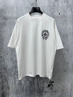 White short-sleeve T-shirt with small black circular graphic on the chest