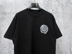 Black short-sleeve T-shirt with small circular chrome-style chest graphic