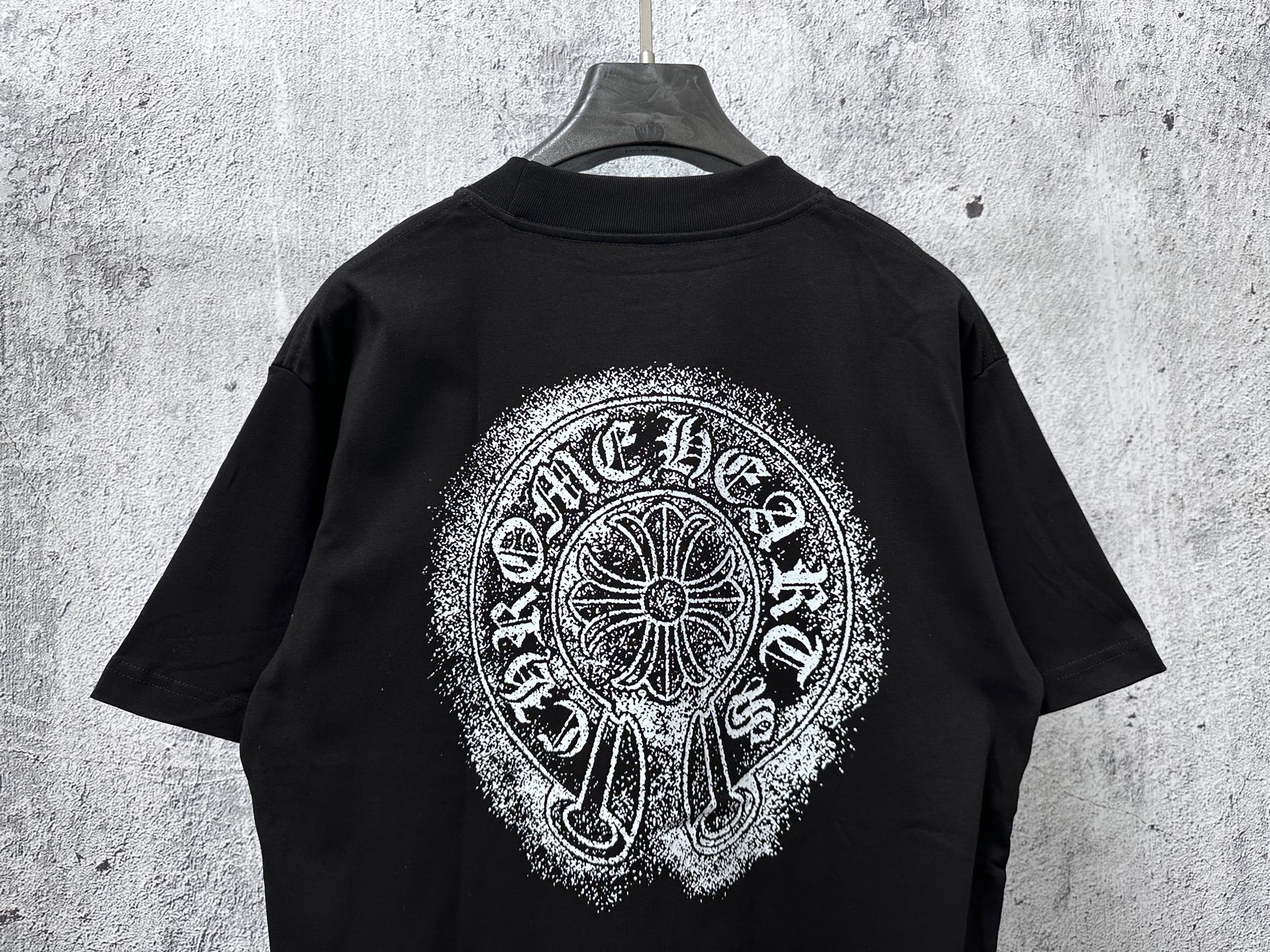 Black short-sleeve T-shirt with large circular chrome-style back graphic