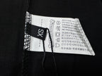 Black T-shirt interior neck label and care tag with size marking