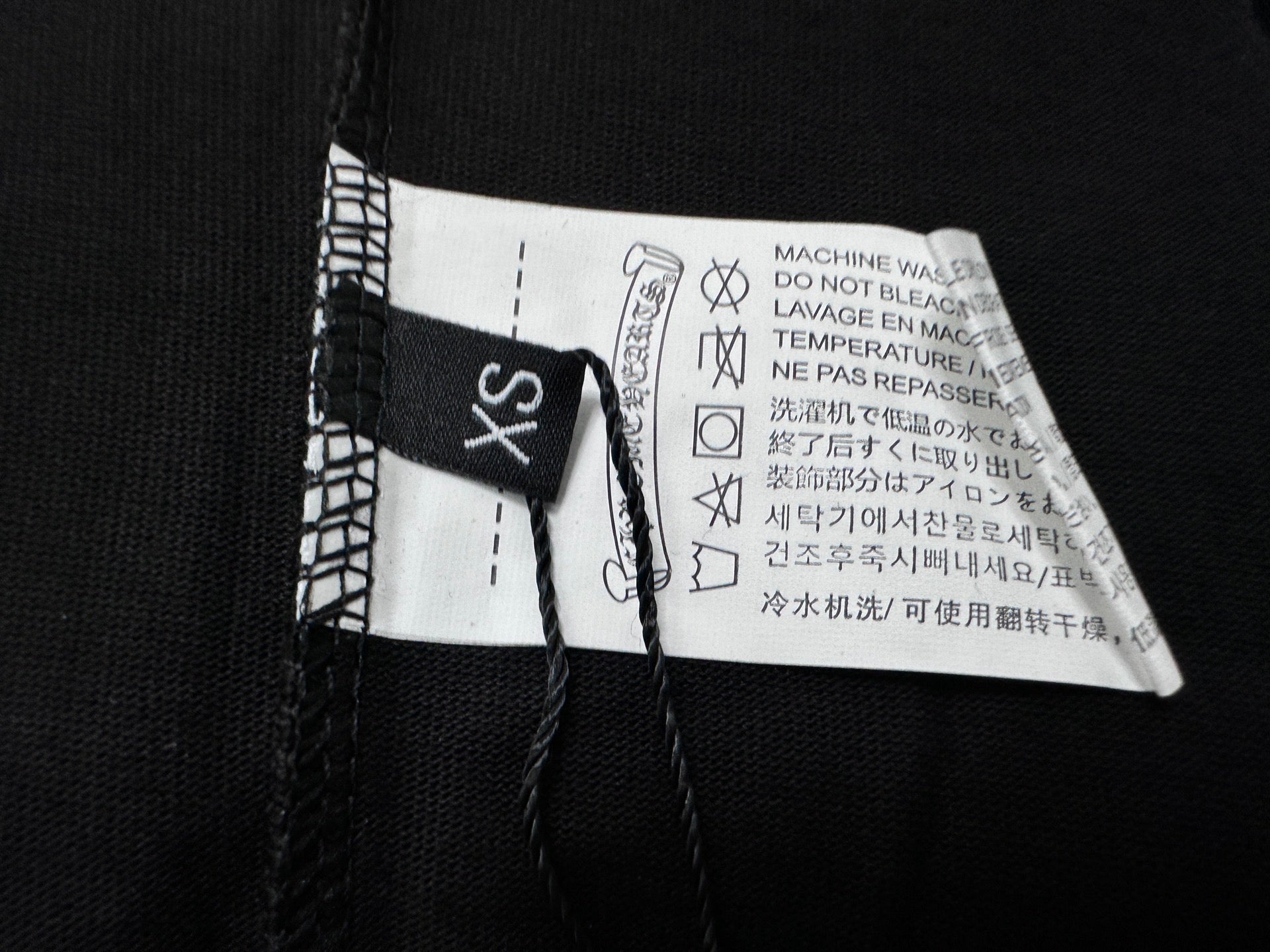 Black T-shirt interior neck label and care tag with size marking
